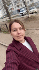 Woman records selfie video under cloudy urban skies
