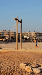 Quarteira beach at golden hour: swings, paddleboards, and a passing vessel