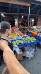 Tourist documents vibrant market visit in Ubud, Indonesia