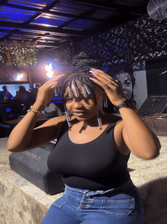 Woman poses at music venue in Howayi, Nigeria