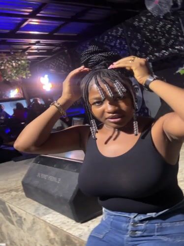 Woman poses at music venue in Howayi, Nigeria