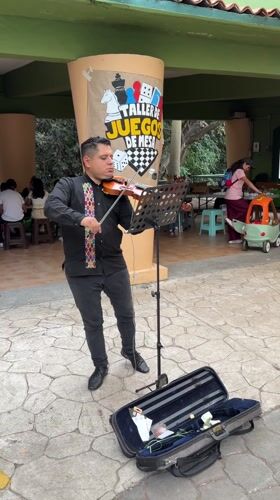 Violinist performs on stone patio in Cuernavaca, Mexico