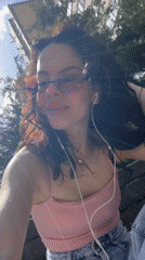Woman relaxes, takes selfies on park bench in Krasnodar
