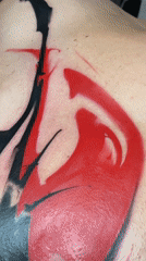 Tattoo session with red and black ink documented in Moscow
