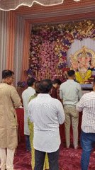 Ganesha puja in progress at a decorated Mumbai shrine