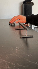 Person practices fingerboarding and drumming in Yekaterinburg apartment