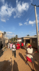 Community parade observed on dirt road in Lokoja
