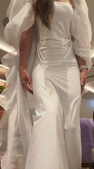 Woman poses for video in white dress at Montenegro hotel