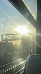 Train passenger records sun-glared view of London railway tracks
