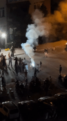 Nighttime street celebration in Konya with dancing and fireworks