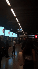 Commuters wait on subway platform in Providencia, Chile