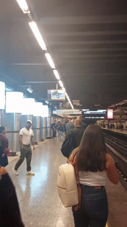 Commuters wait on subway platform in Providencia, Chile