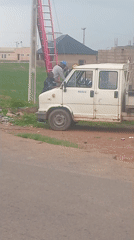 Utility workers service power line in Du, Nigeria