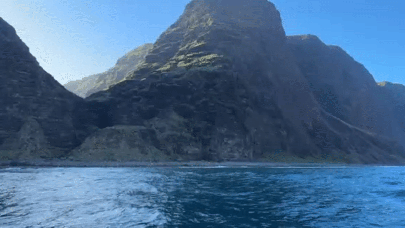 Coastal footage captured near Waimea shows dramatic cliffs and choppy seas