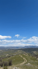 Hikers walk trail to cross monument in Bata, Bulgaria