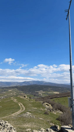 Hikers walk trail to cross monument in Bata, Bulgaria