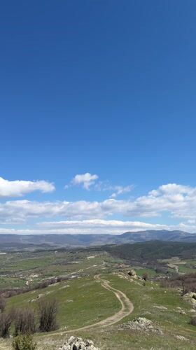 Hikers walk trail to cross monument in Bata, Bulgaria