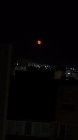 Orange supermoon rises over Odesa skyline on summer night