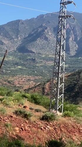 Rural electrical infrastructure documented in mountainous Morocco landscape