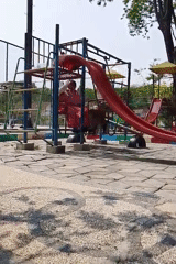Morning play at a colorful community playground in Tlogobendung