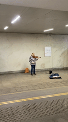 Street musician plays violin in Moscow subway underpass