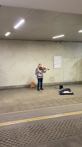 Street musician plays violin in Moscow subway underpass