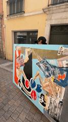 Person carries abstract painting through Toulon street