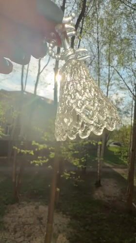 Person holds glass bell, ceramic mug outdoors in Dmitrov
