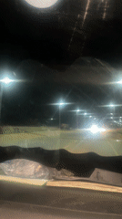 Dashcam captures nighttime traffic encounter with oncoming headlights