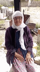 Elderly woman and woodcarver observed in morning Caracas scene