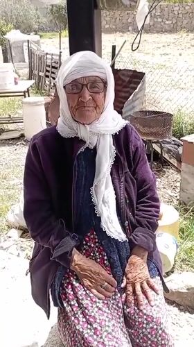 Elderly woman and woodcarver observed in morning Caracas scene