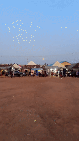 Full moon observed over Kurunduma Nigeria market at twilight