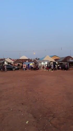 Full moon observed over Kurunduma Nigeria market at twilight