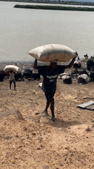 Workers transport sacks near waterway in Lokoja, Nigeria