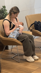 Woman bottle-feeds baby in Coquitlam waiting area