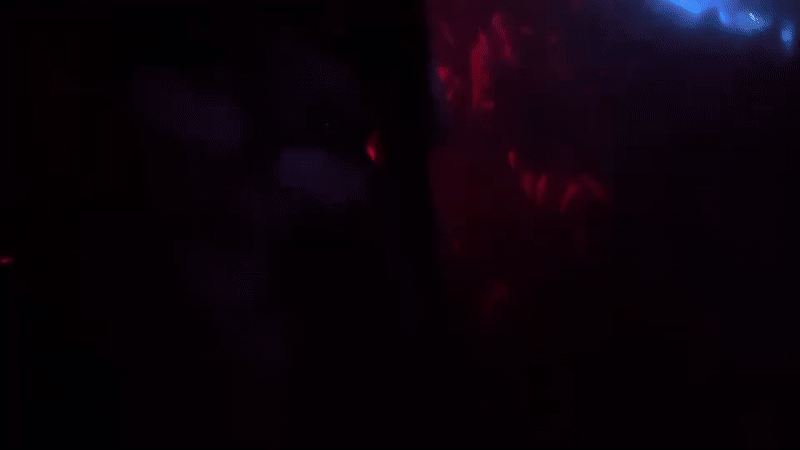 Milan club night: red lights, DJ set, and aerial performance