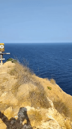 Rocky clifftop road meets Mediterranean blue, l'Alfàs del Pi