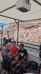 Boat tour and beach bar vibes along a rocky coastline