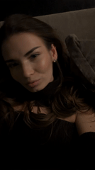 Woman poses for camera on couch in Romashkovo