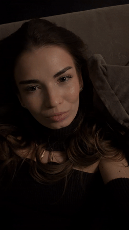 Woman poses for camera on couch in Romashkovo