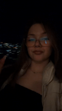 Woman smoking outdoors at night in Veliko Tarnovo