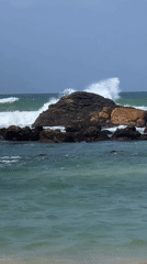Midigama's rocky coastline and offshore island on a cloudy morning