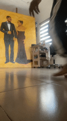 Inside an artist's space in Ado, Nigeria, surrounded by paintings.
