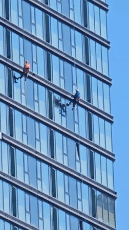 Window washers service high-rise building in Khimki, Russia