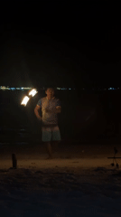 Fire spinner performs nighttime beach show in Indonesia