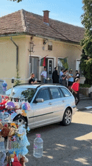Brass musicians perform on building steps in Bulgarian village