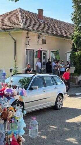 Brass musicians perform on building steps in Bulgarian village