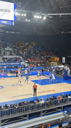 Basketball game underway in Krasnoyarsk arena with spectators present
