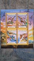 Stamp collector documents dinosaur and turtle themed postal collections