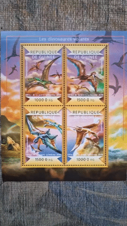 Stamp collector documents dinosaur and turtle themed postal collections